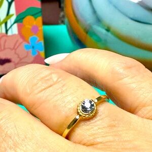 Delicate gold tone ring, and gemstone size 7